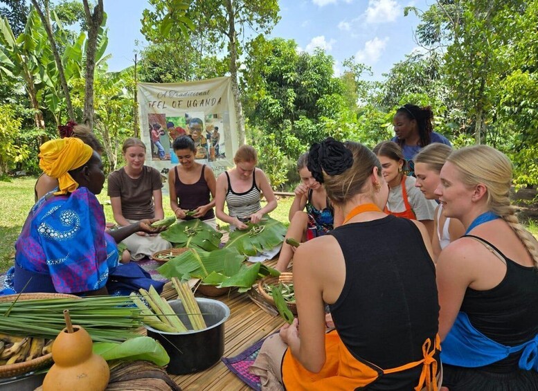 A group of people engaged in a traditional Ugandan activity outdoors, surrounded by lush greenery. 2