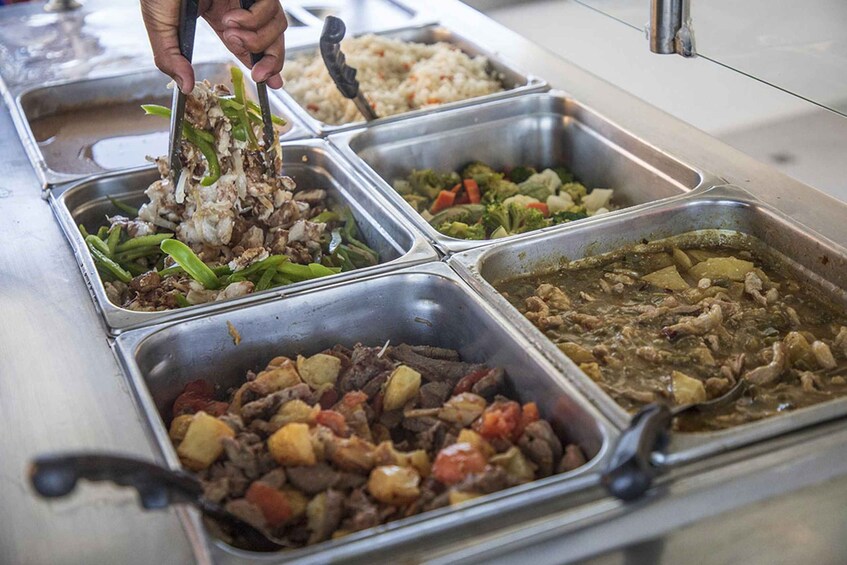A buffet with various dishes including rice, vegetables, and meat. 2