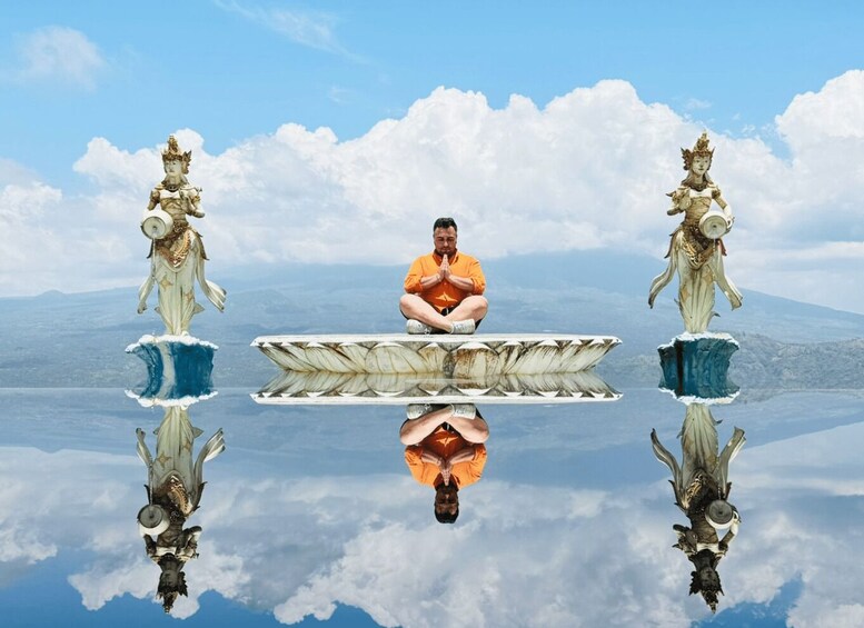 A man meditating on a floating platform with statues on either side. 3