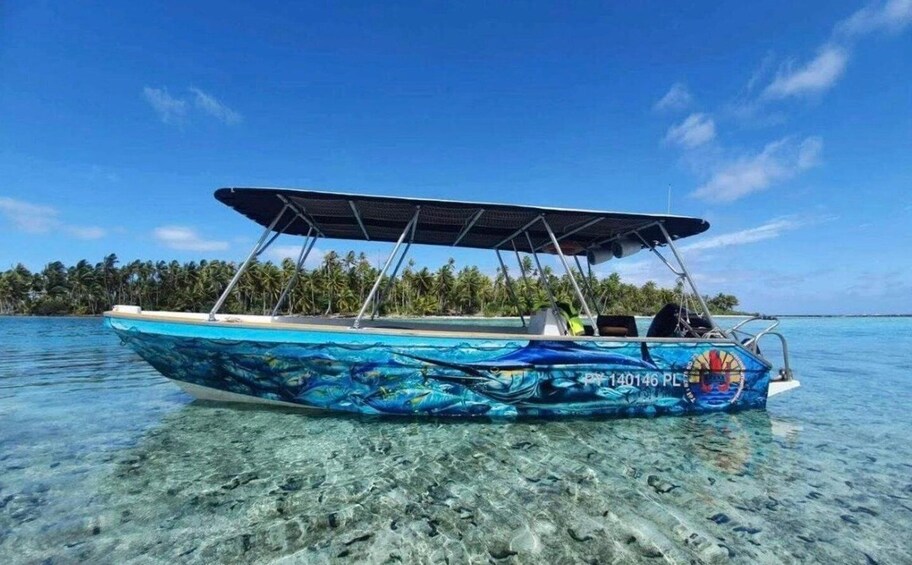 A blue boat with a canopy, floating on clear water with a tropical backdrop. 5