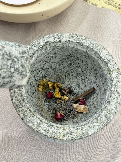 A stone mortar with dried flowers and spices. 4