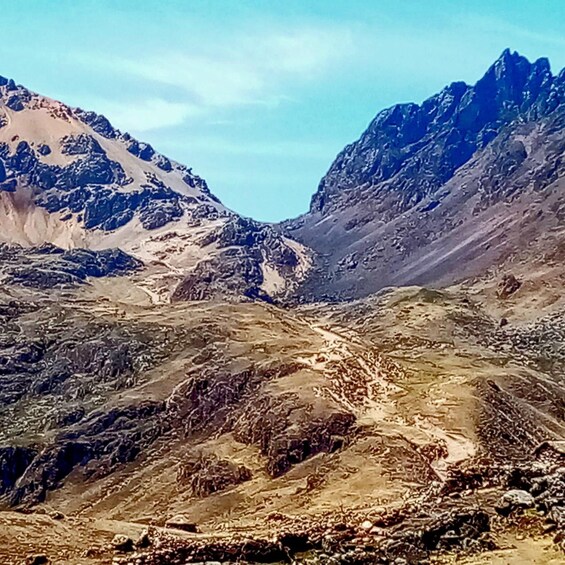 A mountainous landscape with rugged terrain and rocky outcrops. 3