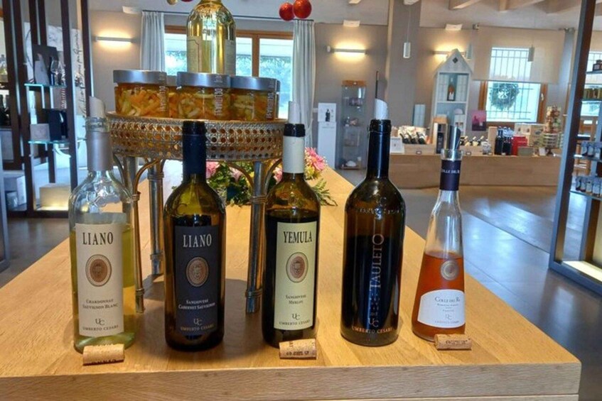 A selection of wine bottles on a wooden display with a backdrop of a store interior. 3