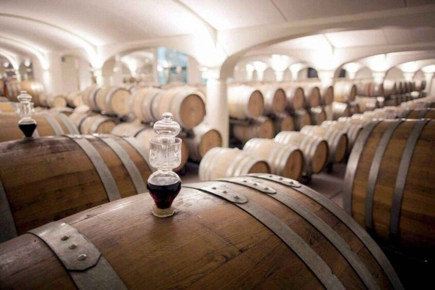Rows of wooden wine barrels in a storage facility. 5