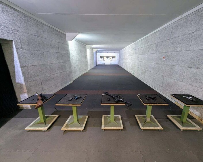 A shooting range with five targets and a clear path leading to the shooting area. 3