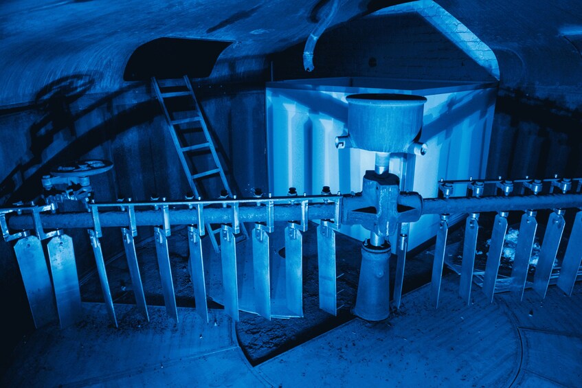 A large industrial machine with a funnel and multiple vertical pipes. 4