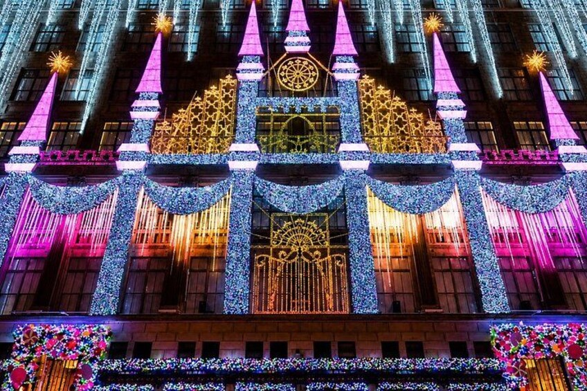A building with illuminated geometric patterns and a large circular design at the center. 3