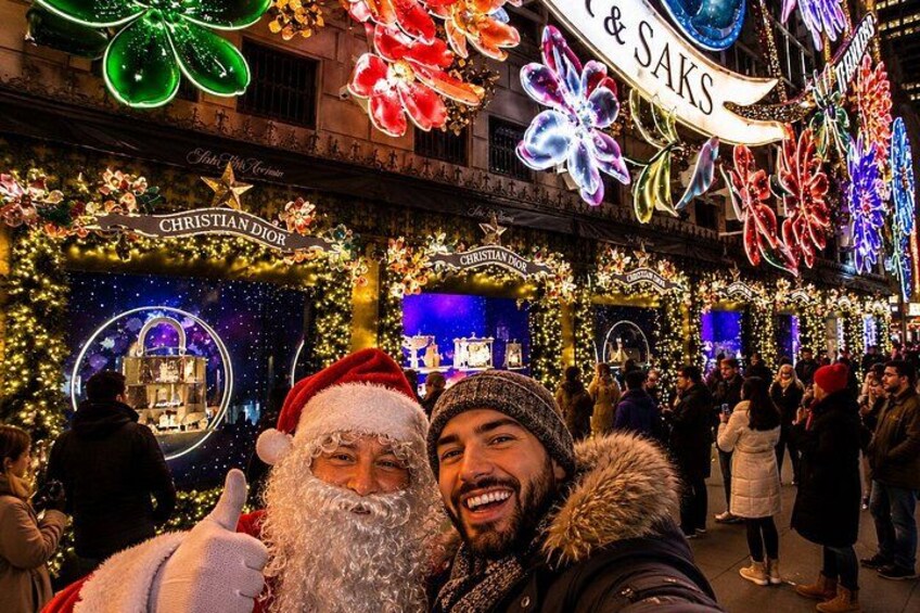 A festive street scene with illuminated Christmas decorations, storefronts, and a crowd of people. 2