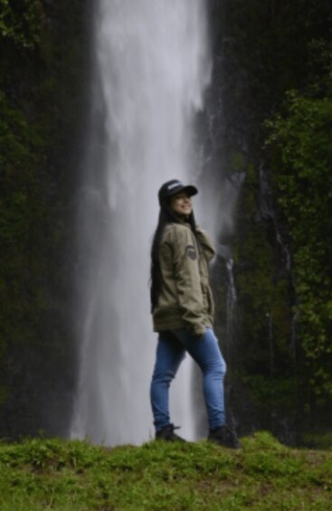 A person standing in front of a waterfall. 4