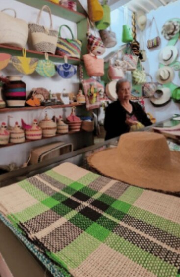 A store with various bags and hats on display. 5