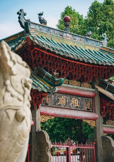 A traditional Chinese gate with ornate decorations and a lion head sculpture. 2