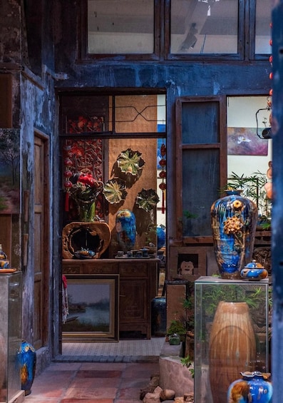 A rustic interior with traditional Chinese pottery and decorative items. 4