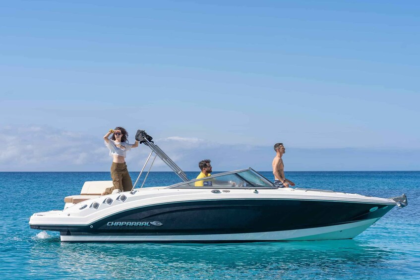 A boat named 'CHAPARRAL' on calm blue waters with a clear sky. 1