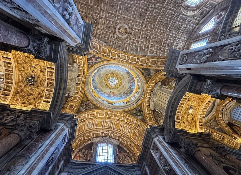 A grand, ornate ceiling with intricate gold detailing and a central circular fresco. 4