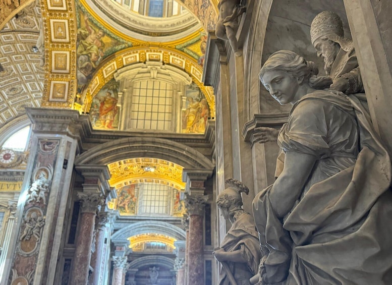 A detailed interior of a historical building with ornate columns, a high ceiling, and classical sculptures. 5