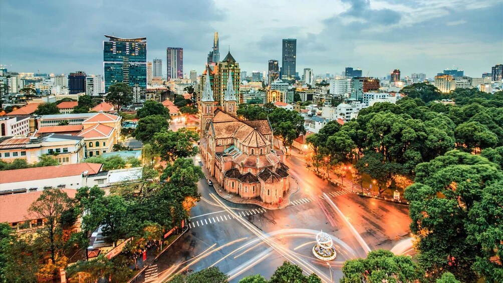 A cityscape with a prominent church, modern skyscrapers, and a mix of greenery. 5