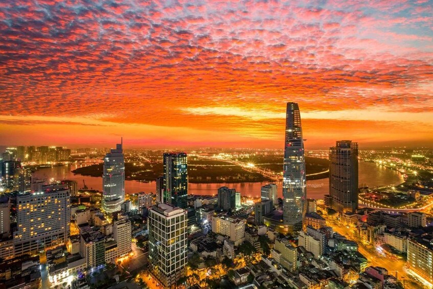 A cityscape at sunset with illuminated buildings and a river. 4