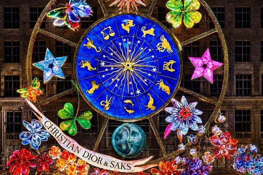 A large, ornate wheel with zodiac symbols and floral decorations. 1
