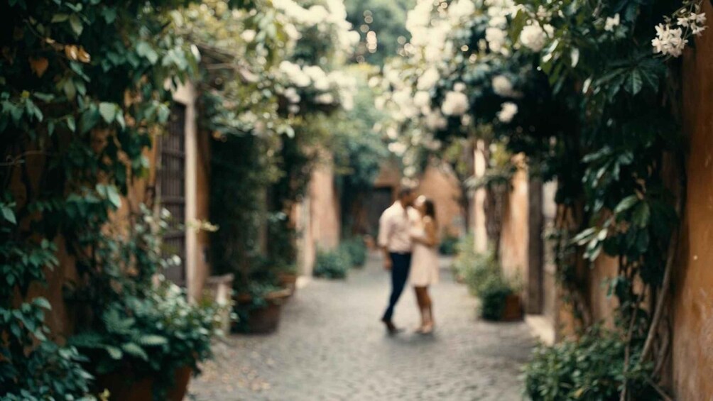 A cobblestone path flanked by lush greenery and flowering plants, leading to a building with a wooden door. 5
