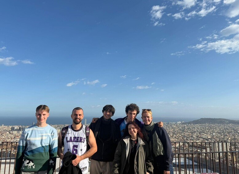 A group of people standing on a high vantage point overlooking a cityscape. 5