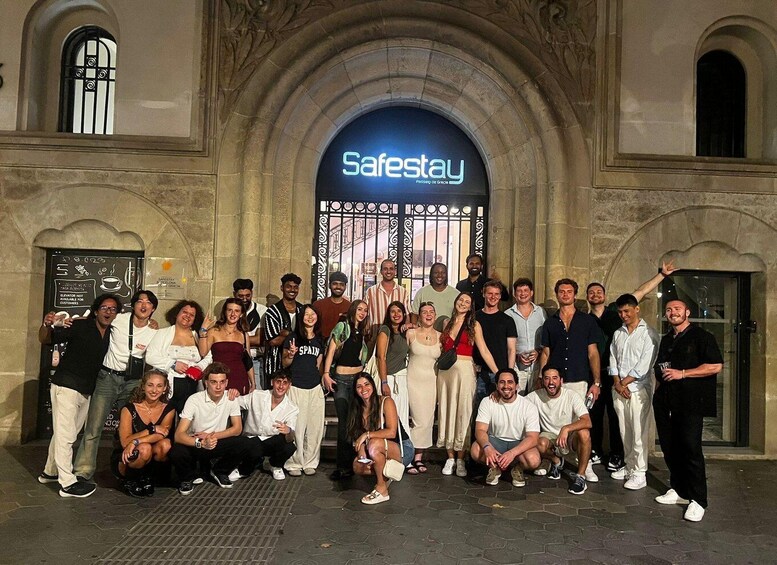 A group of people posing in front of a building with a 'Safestay' sign. 1