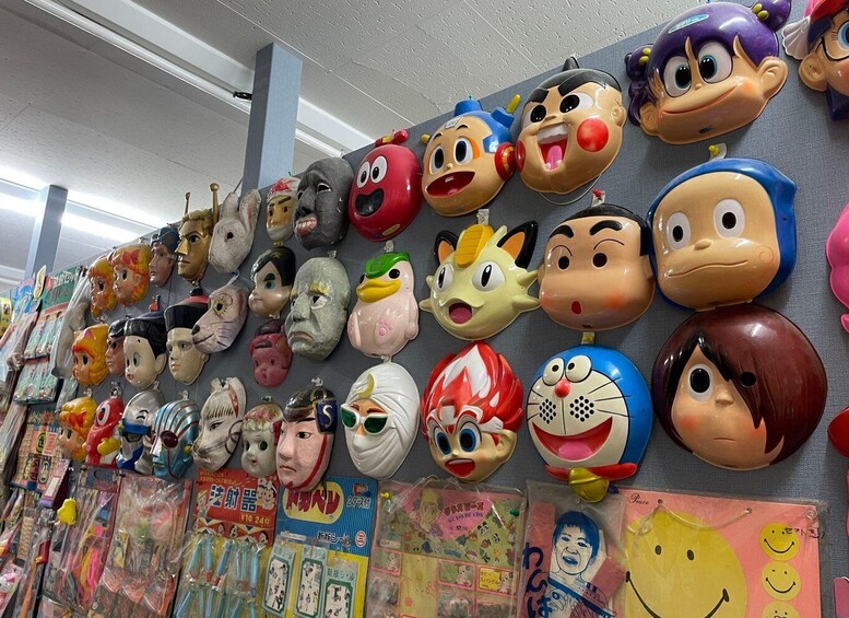 A wall of various colorful masks and character figurines. 2
