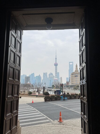 A cityscape with a prominent tower, a bridge, and a cyclist. 1