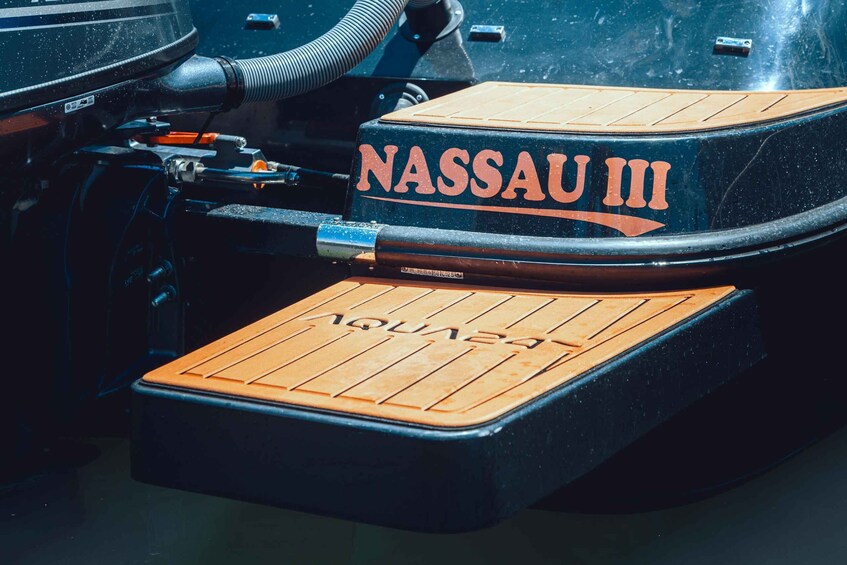A boat with 'NASSAU III' written on its side. 5