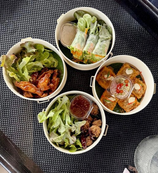 Four bowls of food with different dishes including lettuce, meat, and sauces. 2