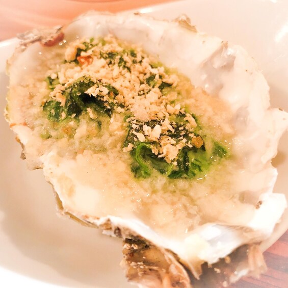 A bowl of soup with a creamy base, topped with green herbs and crumbled cheese. 3