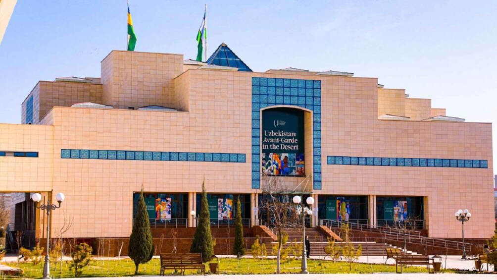 A modern building with a prominent entrance and a large banner. 4