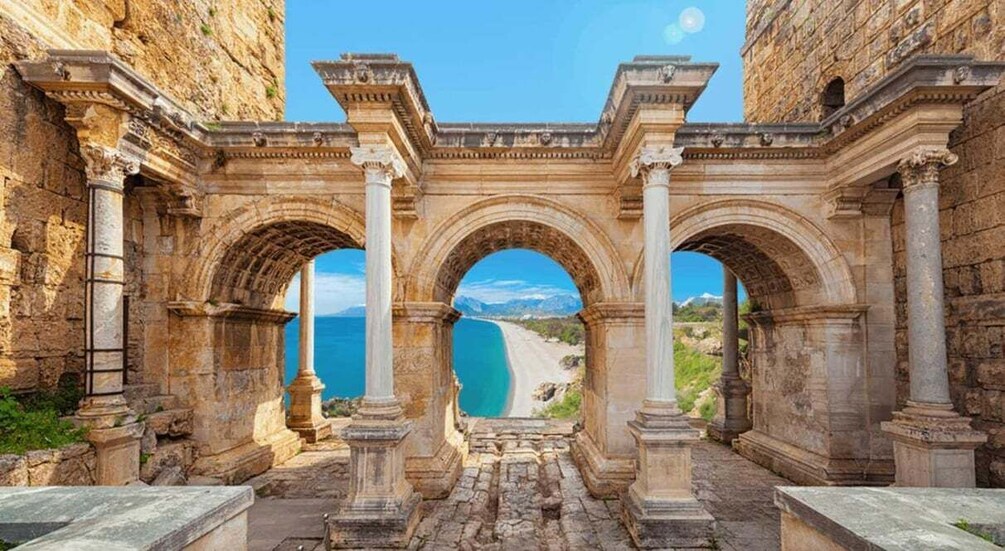 Ancient stone arches overlooking a coastal road. 3