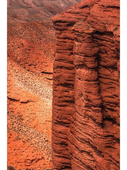 A red rock formation with layered strata. 1