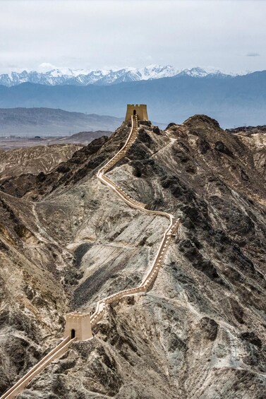 A mountainous landscape with a long, winding road leading to a castle-like structure. 3