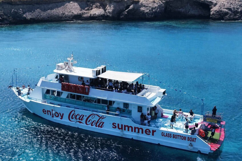 A glass-bottom boat with 'enjoy Coca-Cola summer' written on its side. 1