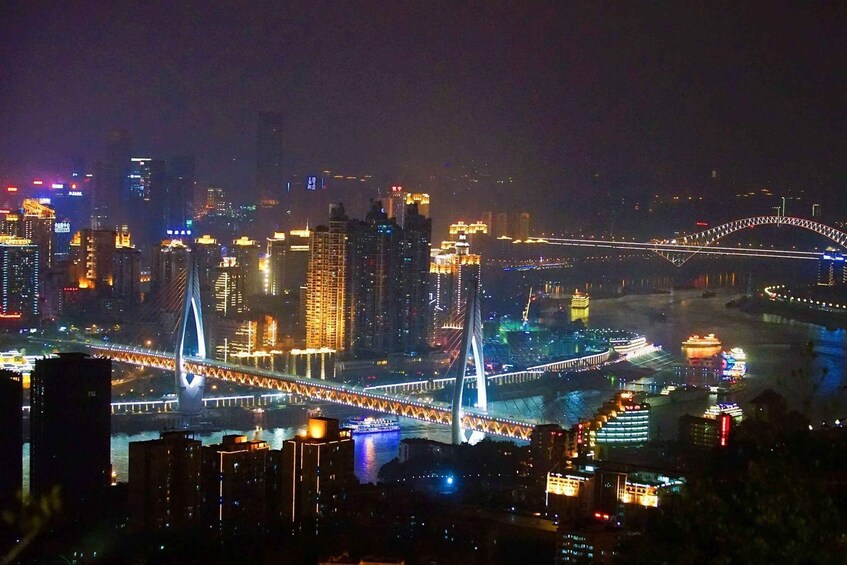 A cityscape at night with illuminated bridges and buildings. 2