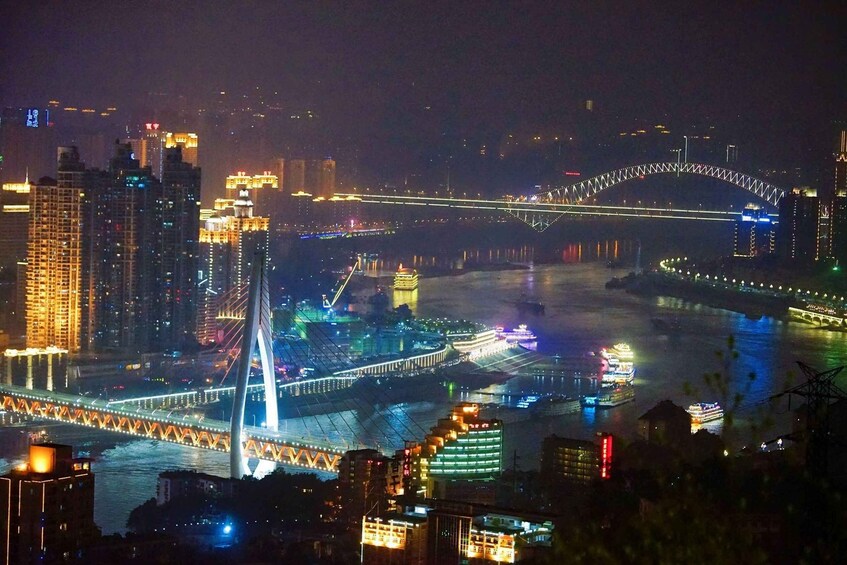 A cityscape at night with illuminated bridges and buildings. 3