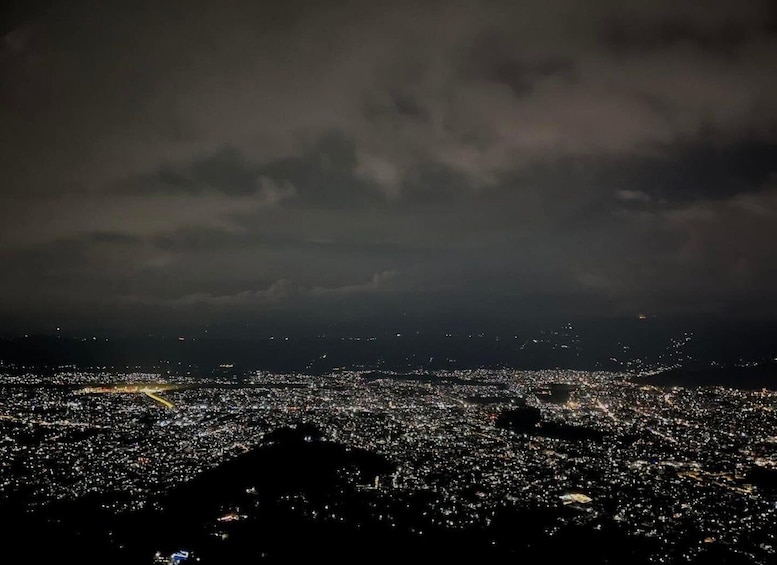 A nighttime cityscape with a cloudy sky. 5