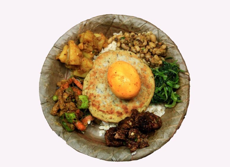 A traditional meal with a variety of dishes including a flatbread, a boiled egg, and assorted sides such as vegetables and meat. 1