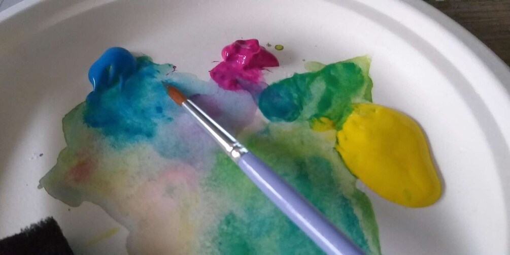 A paint palette with various colors and a paintbrush. 4