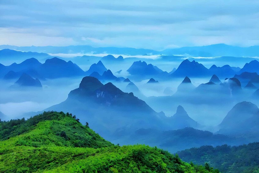 A mountainous landscape with lush greenery and mist-covered peaks. 3