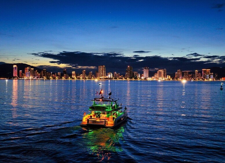 A nighttime cityscape with a brightly lit boat in the foreground. 3