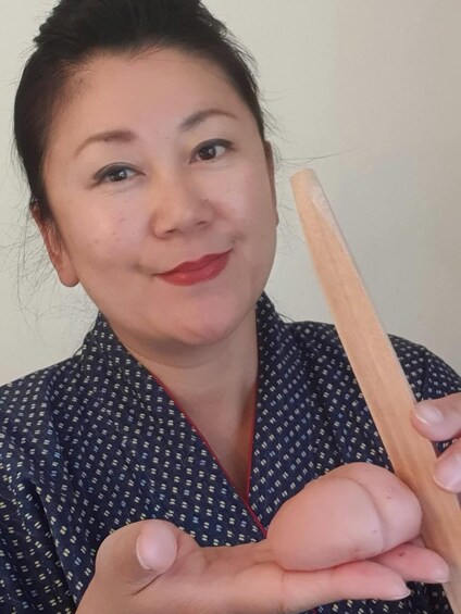 A person holding a wooden object. 3
