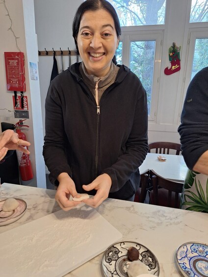 A person at a table with a plate of food, a fire extinguisher, and a Christmas decoration on the wall. 4