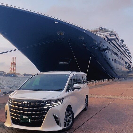 A white Toyota SUV parked in front of a large cruise ship. 1