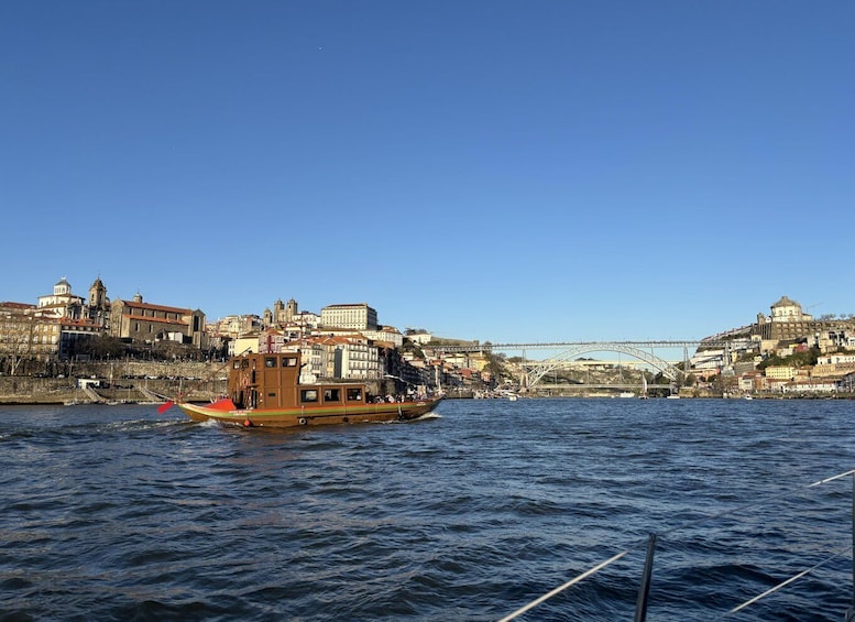 A river with a boat, a bridge, and historic buildings along the banks. 3
