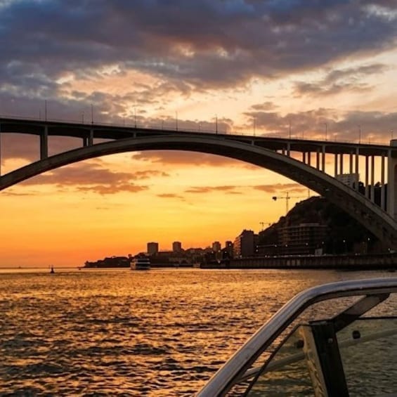 A sunset over a river with a bridge and city skyline. 5