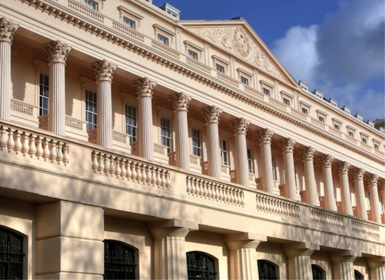 A classical building with columns and ornate balconies. 3