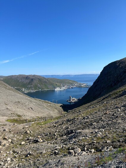 A mountainous landscape with a harbor and a distant city. 3