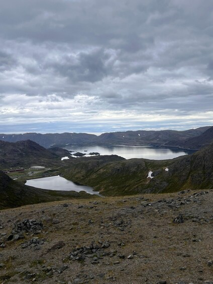 A mountainous landscape with a lake and a small settlement. 5